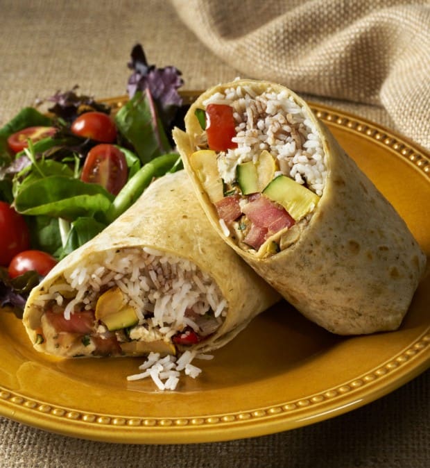 Vegetarian Sandwich Wrap or burrito made up of saute yellow squash, zucchini, bell peppers and onions rolled in a corn tortilla with rice and diced tomatoes and goat cheese and drizzled with a balsamic vinaigrette. Wrap is served with a baby lettuce salad.